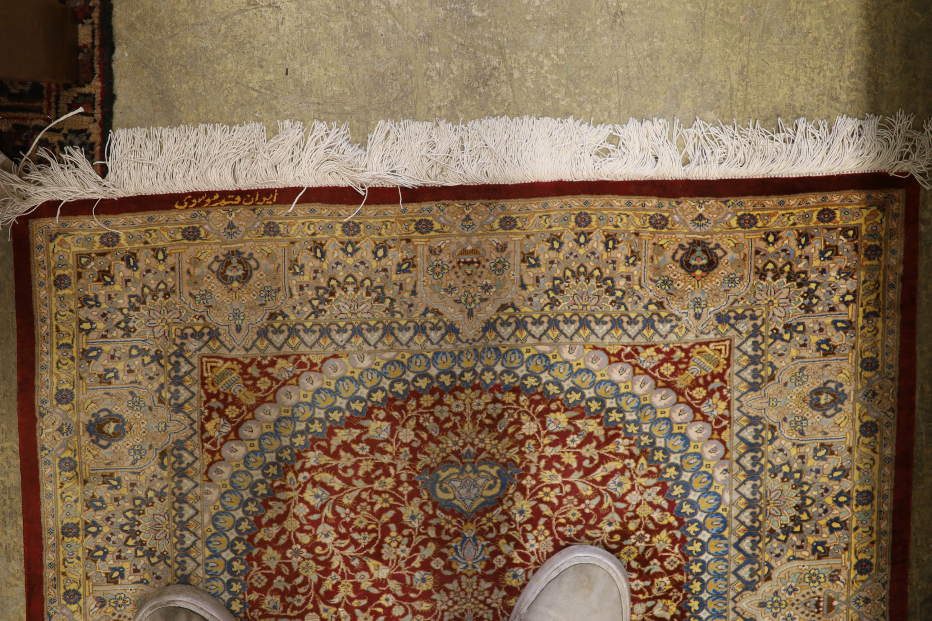 A Persian part red ground silk multi-floral patterned rug, 110 x 80cm